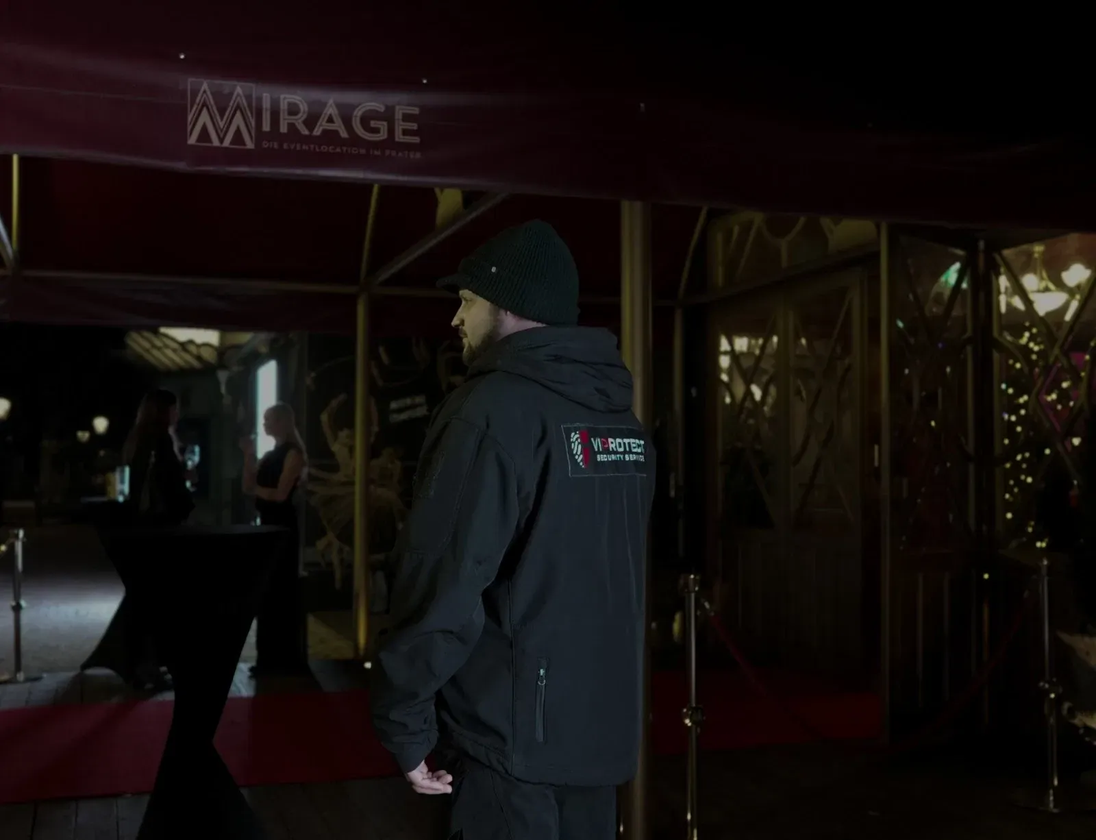 VIPROTECT GmbH Security Service staff member providing professional event security at the entrance at night
